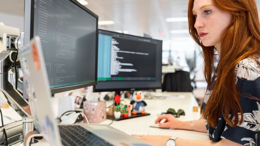 woman coding on computer